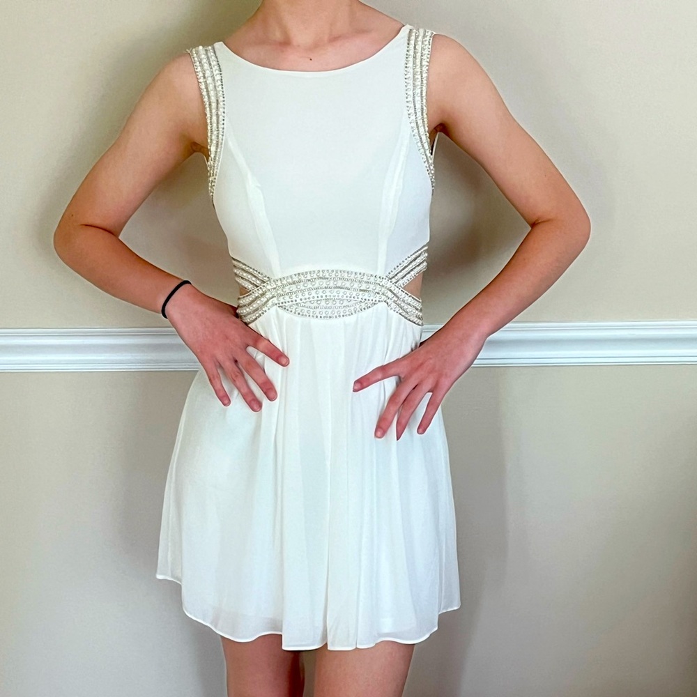 TFNC London party dress with beaded details and side cut-outs.